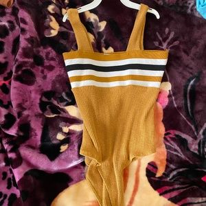 Charlotte Reusse’s yellow mustard body suit